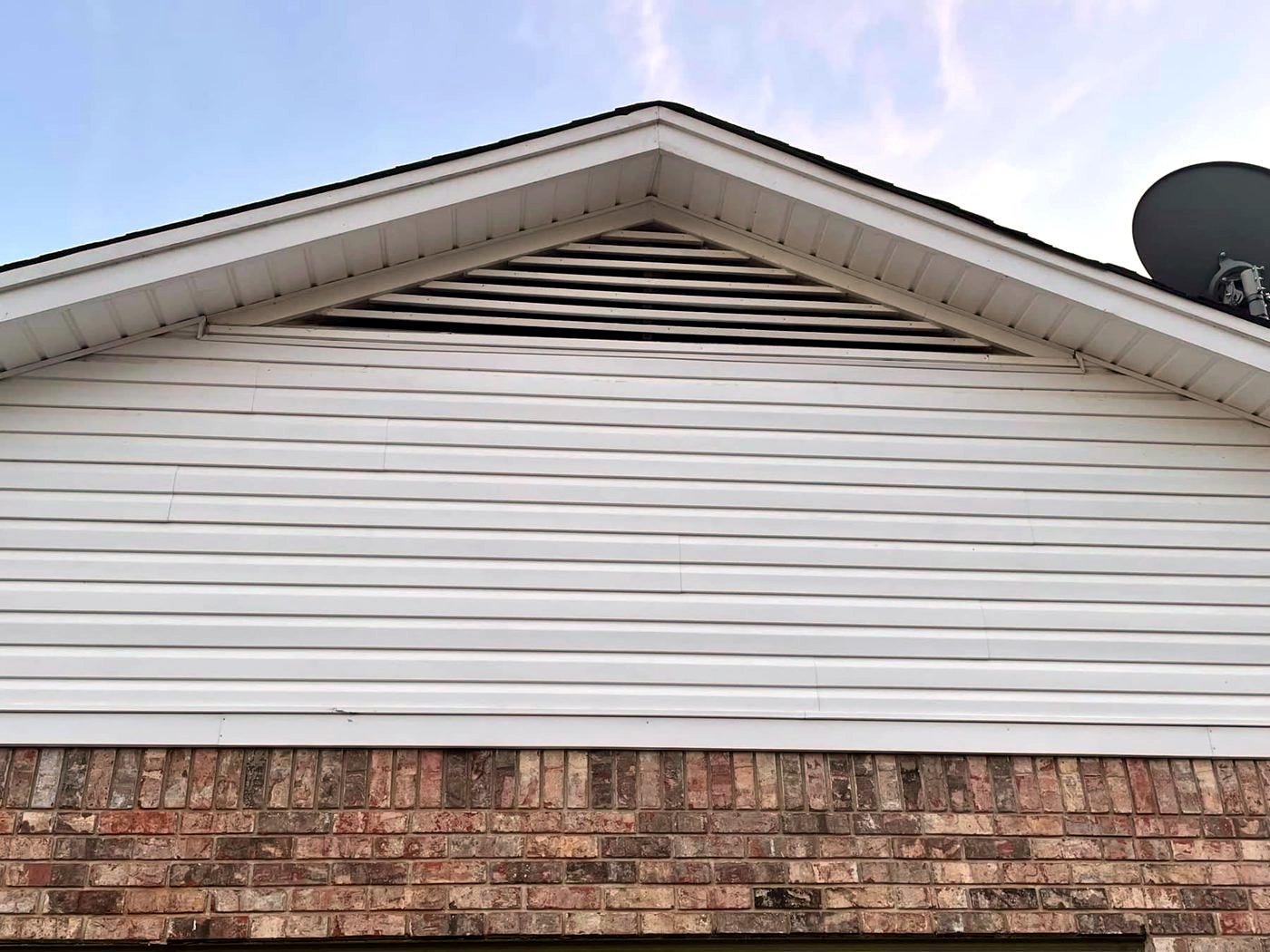 Vinyl siding gable after soft washing, bright white